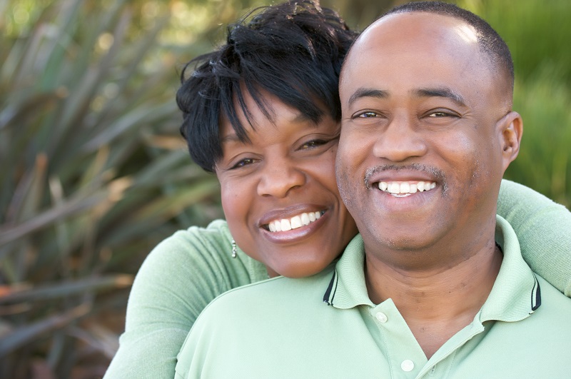 Attractive and Affectionate African American Couple posing in the park.