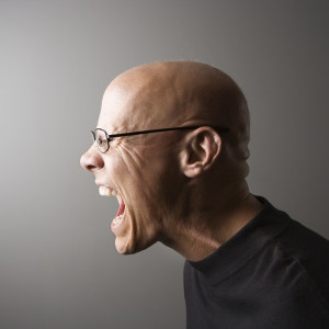 Profile of man screaming.